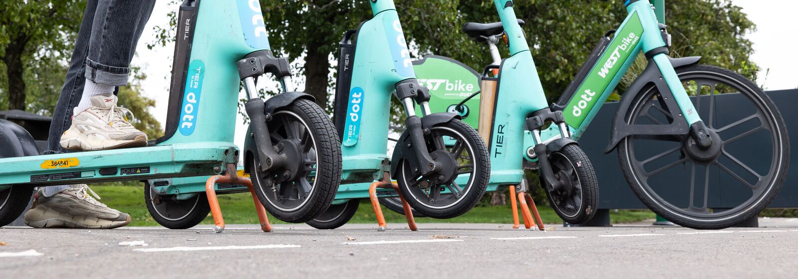 person parking an e scooter