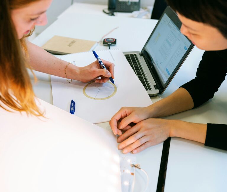 Two people working together on a chart