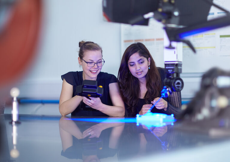 Two ladies working with lasers