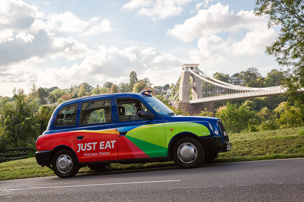 Just Eat taxi with Suspension Bridge in the background