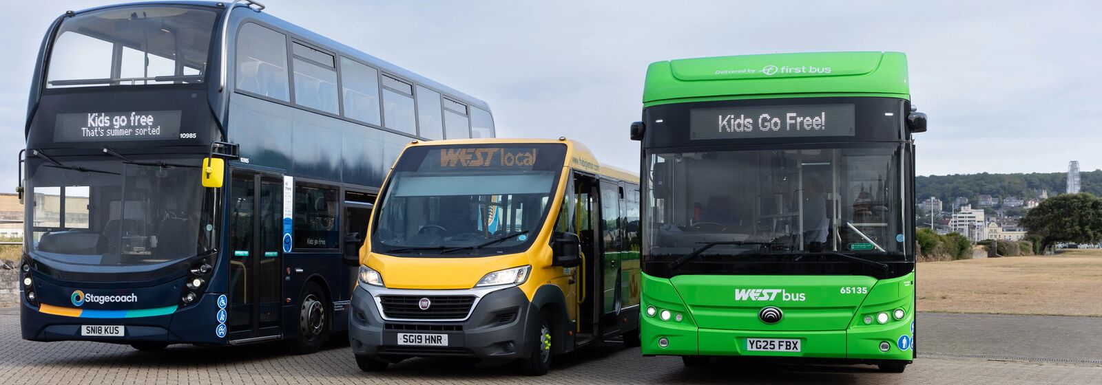 A WESTlocal bus is pictured alongside other buses, promoting Kids Go Free this summer.