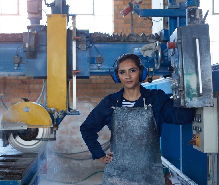 Engineer standing at her equipment