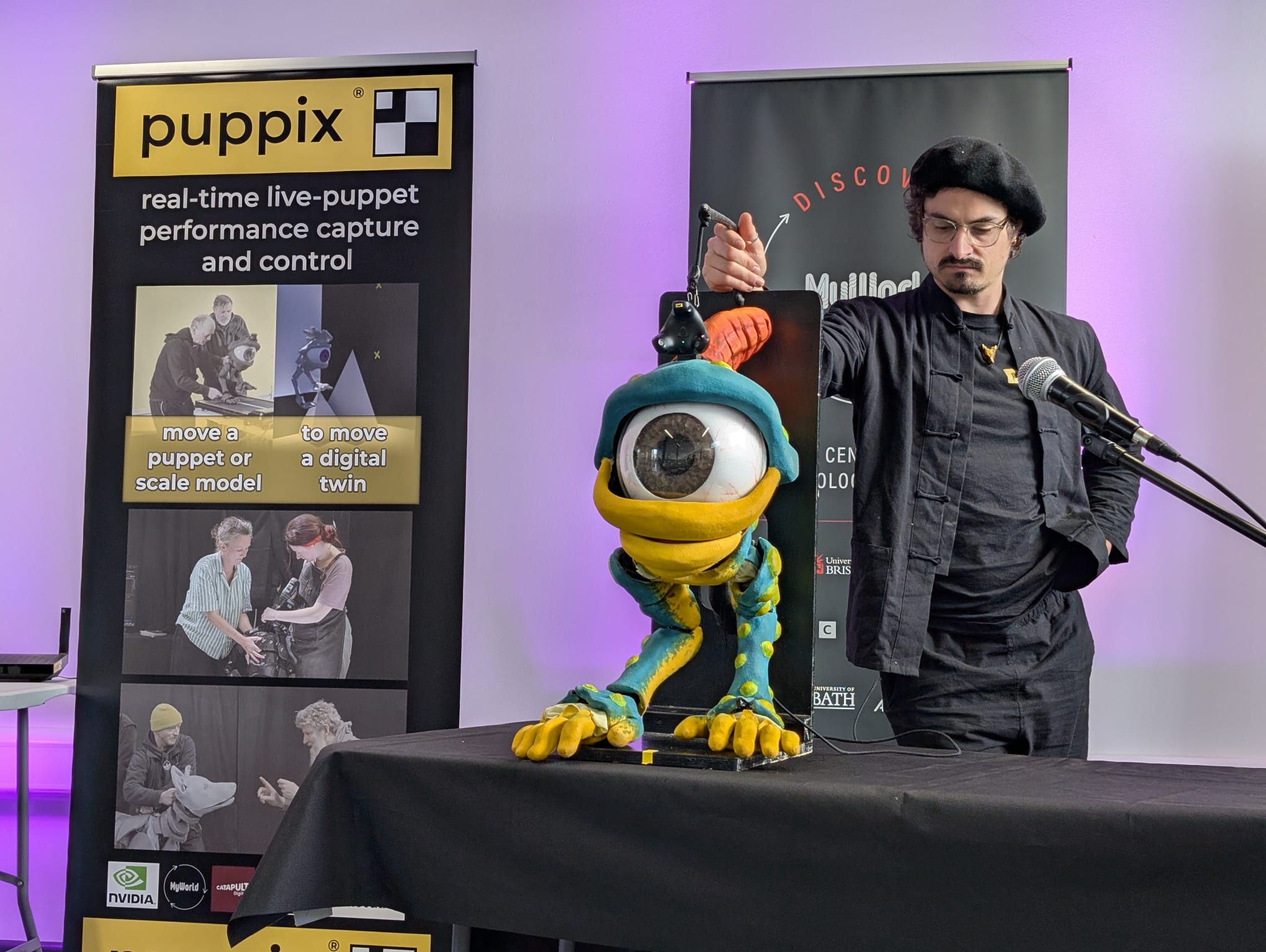 Puppeteer displaying puppet next to a display banner