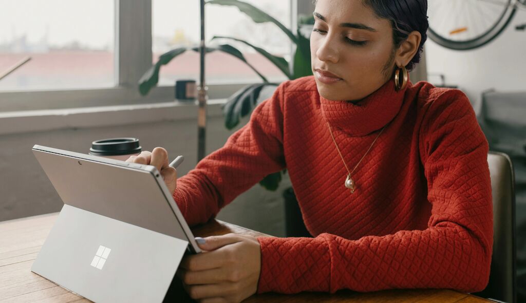Woman using a tablet with a stylus