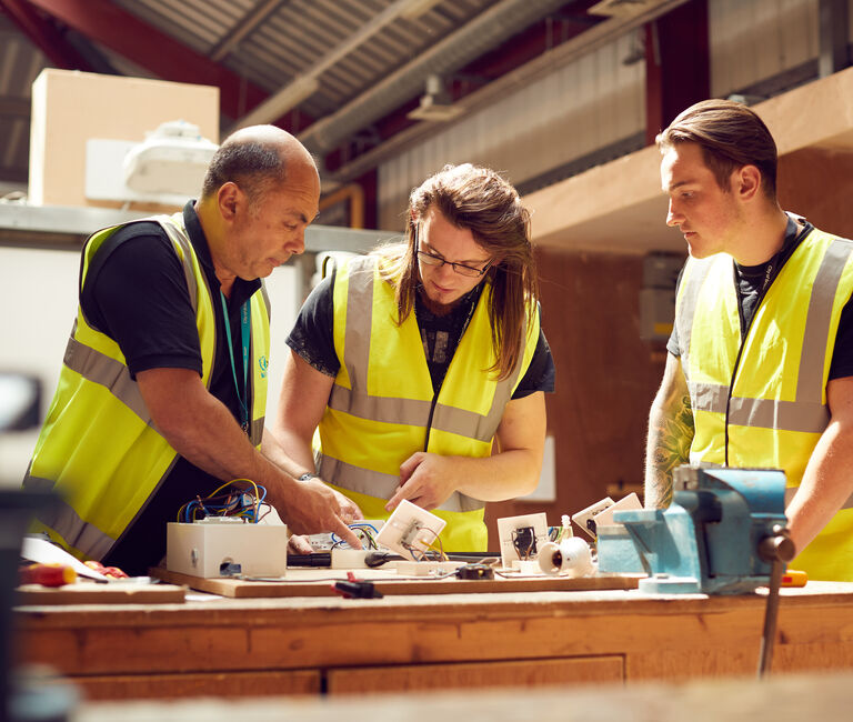 Three people woodworking