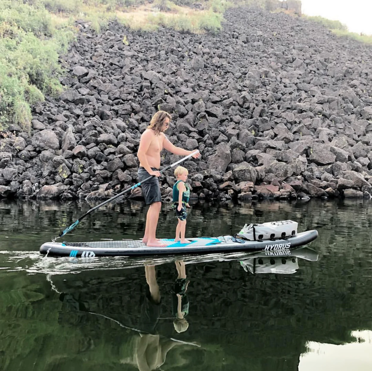 dad and son paddleboarding