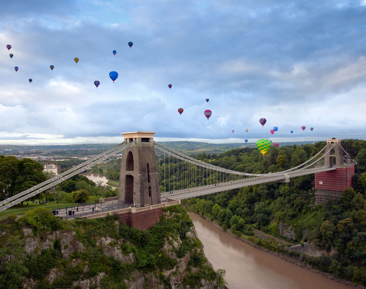 hot air balloons in the sky above clifton suspension bridge