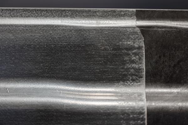 Unidirectional Fiberglass sheet, over molded on a DLFT molded personal watercraft hull