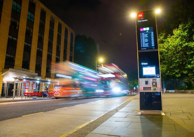 night time scene of metrobus ipoint, bus stop and buses moving