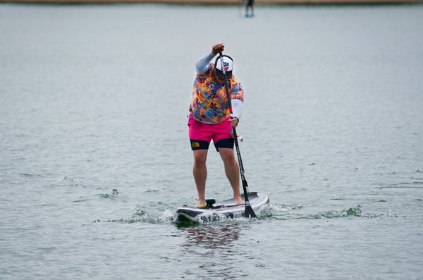 man racing on elysium air paddleboard