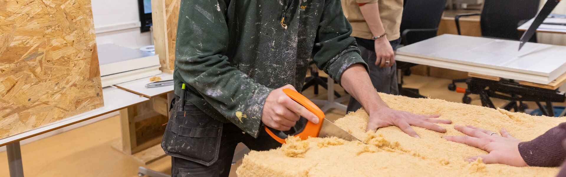 People sawing insulation