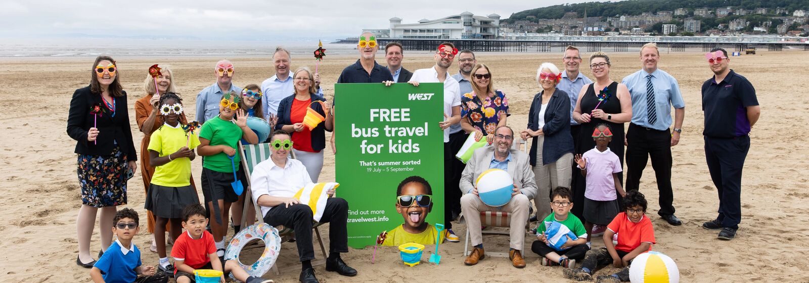 Helen Godwin, the new Mayor of the West of England, and council leaders, bus operators, and school kids are pictured on the beach in Weston-super-Mare with a sign reading 