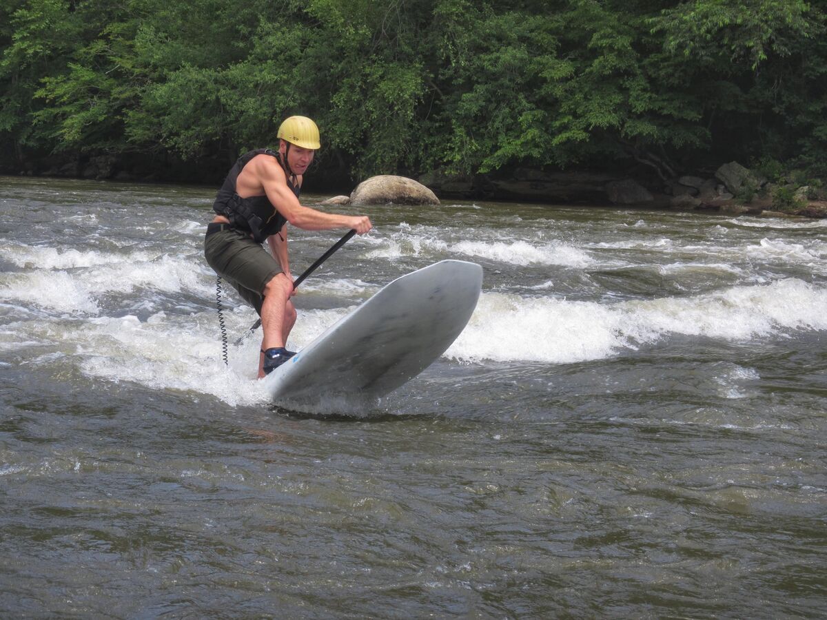 dad white water paddleboarding