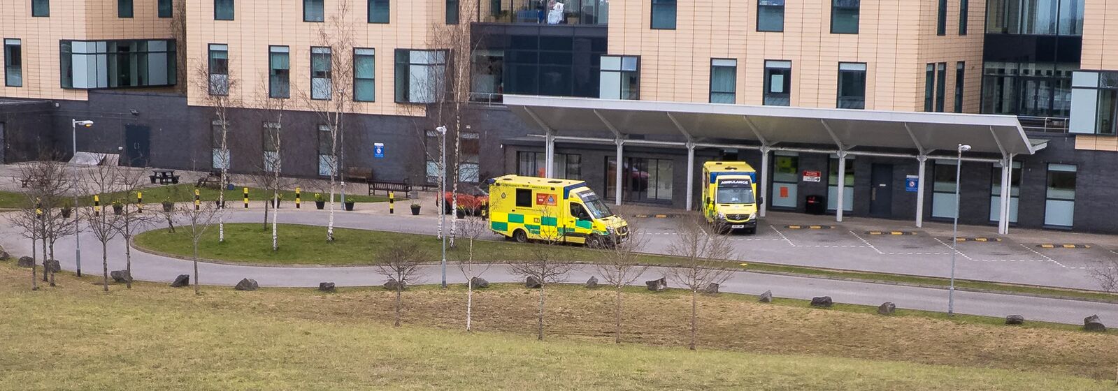 Southmead Hospital is pictured, with ambulances in front.