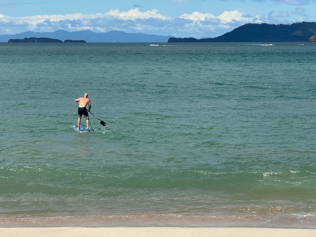 Man paddling in ocean on paddleboard
