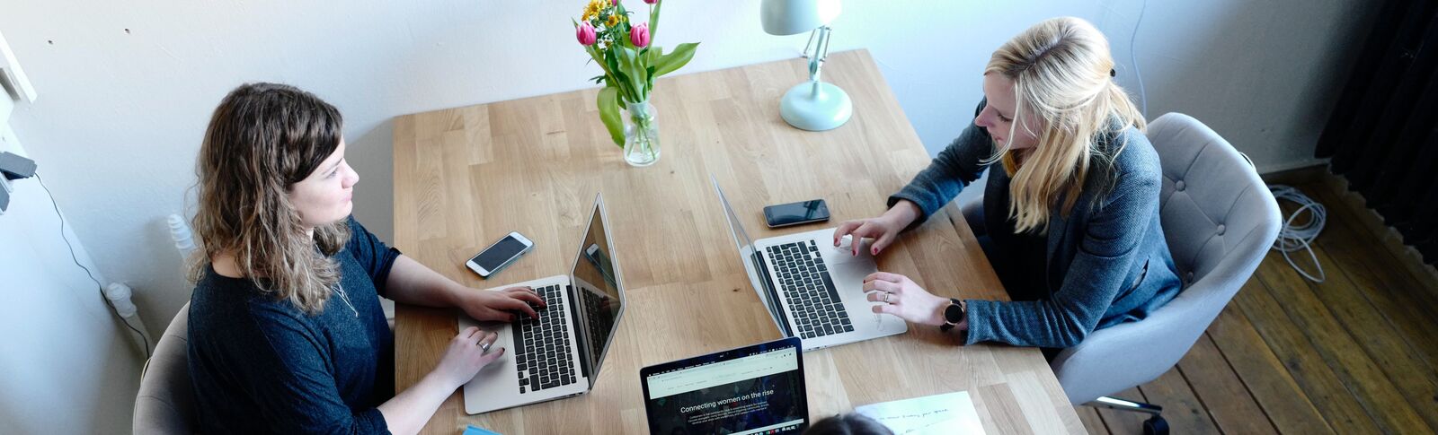 2 people sat together at a desk
