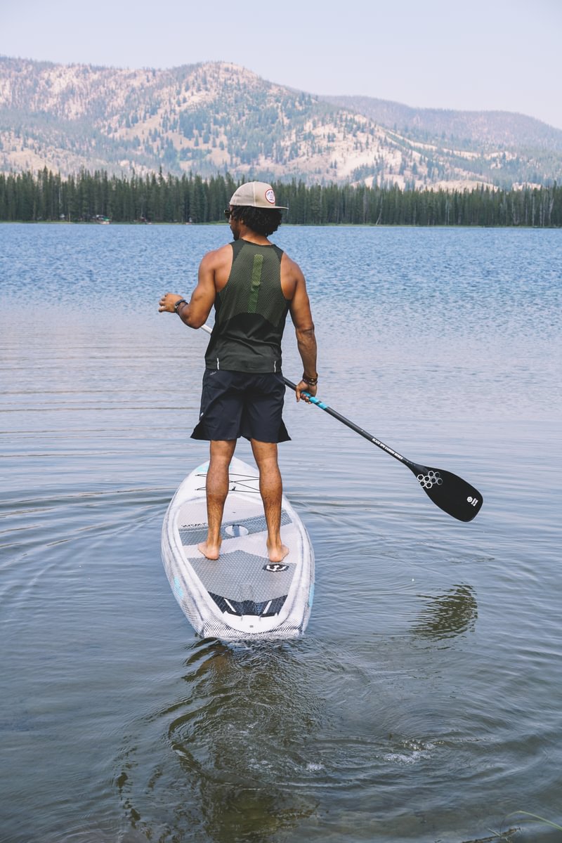 man paddleboarding in lake