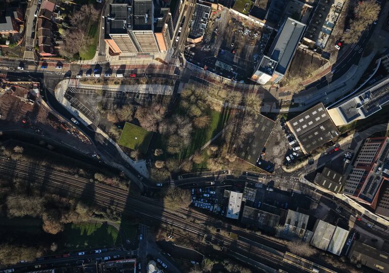 aerial view of built up city with greenery in the middle