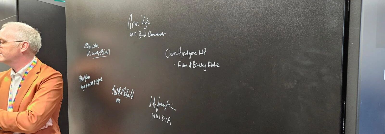 Signatures on a panel of the Isambard-AI supercomputer at NCC/University of Bristol include Helen Godwin, the Mayor of the West of England.