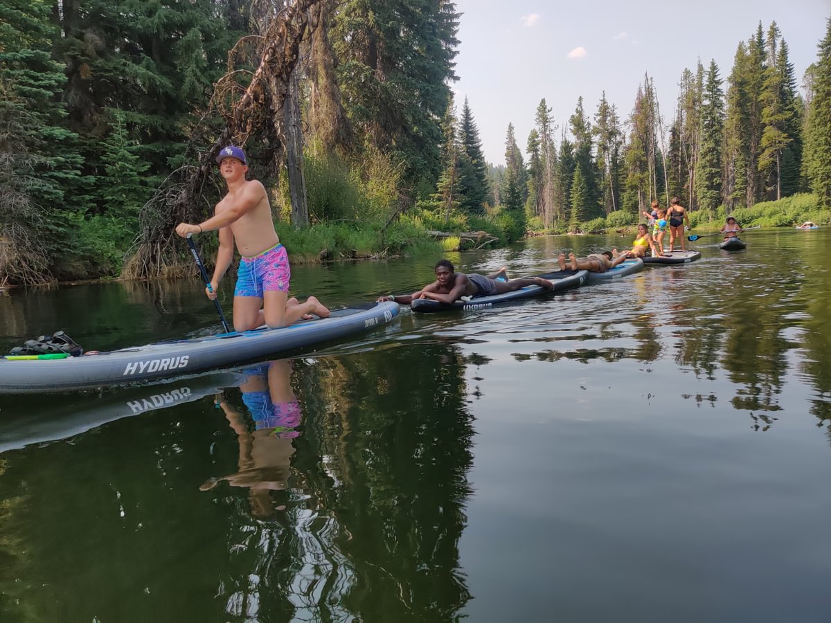 group of people paddle boarding