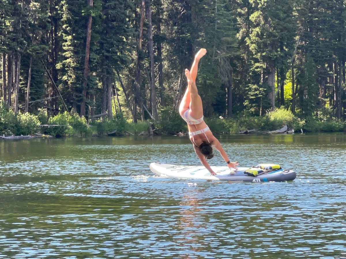 woman falling off of paddleboard