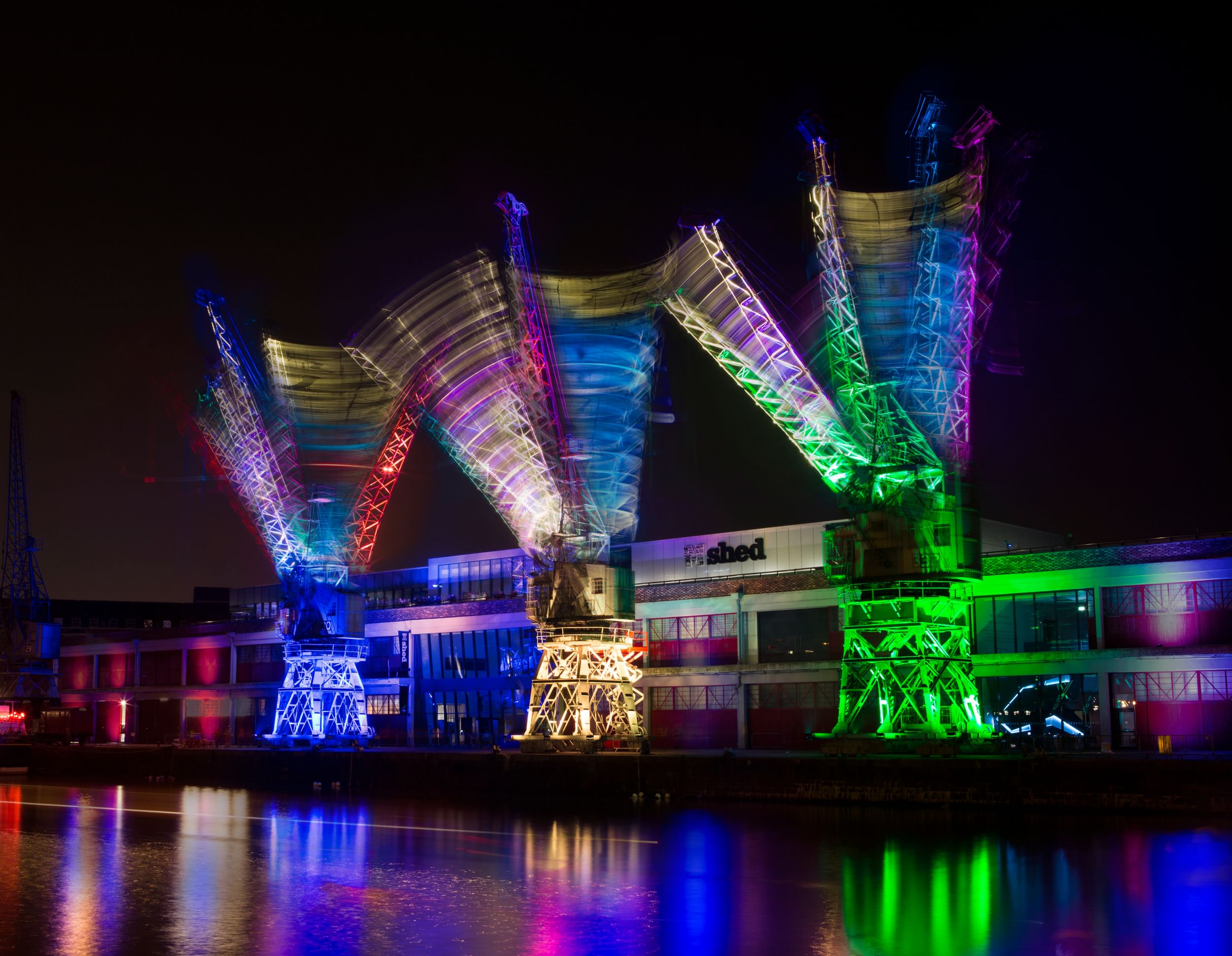 The movement of three of Bristol’s iconic dock cranes, lit up for Crane Dance Bristol