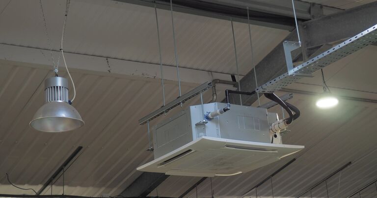 air conditioning unit and lights hanging from ceiling of a new roof