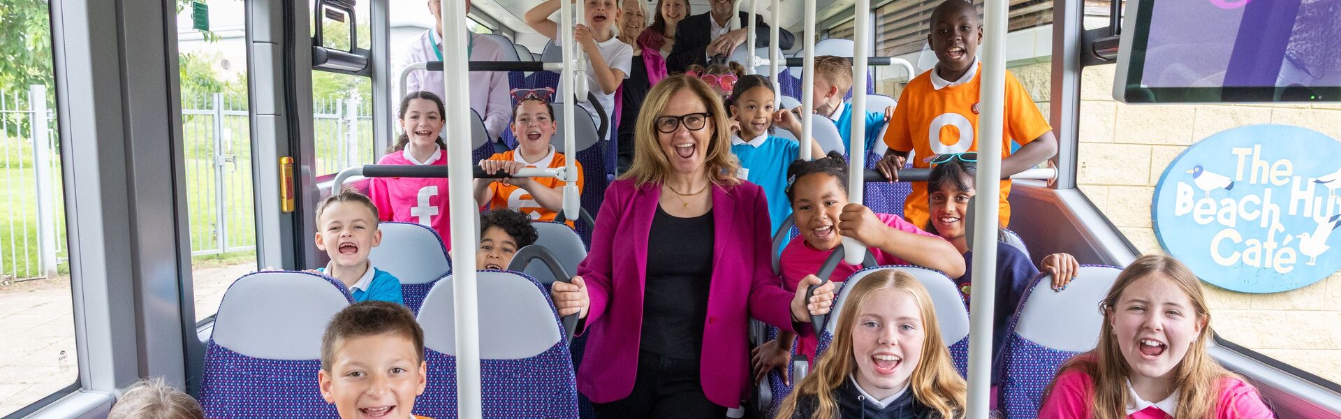 Mayor Helen Godwin inside a bus with lots of happy children