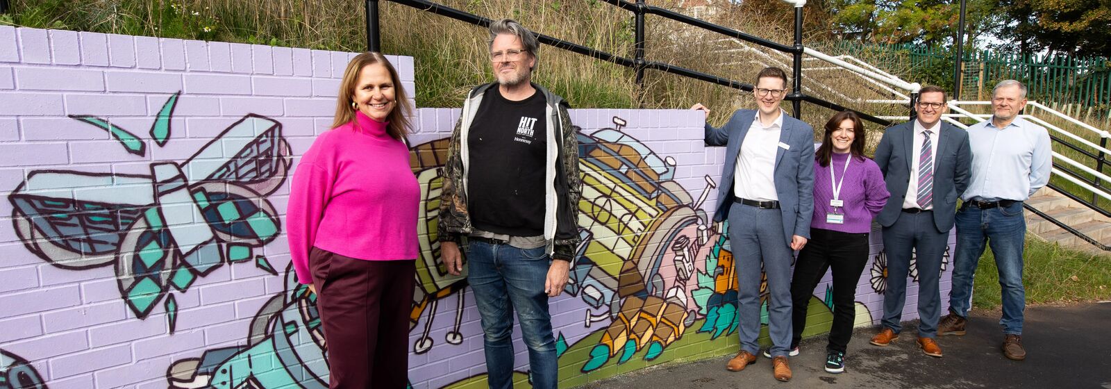 The Mayor, artist, councillors, and partners are pictured with the new mural at Ashley Down train station.