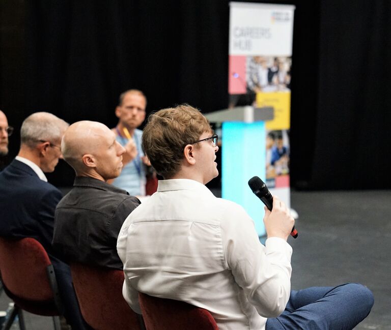 People speaking at a conference
