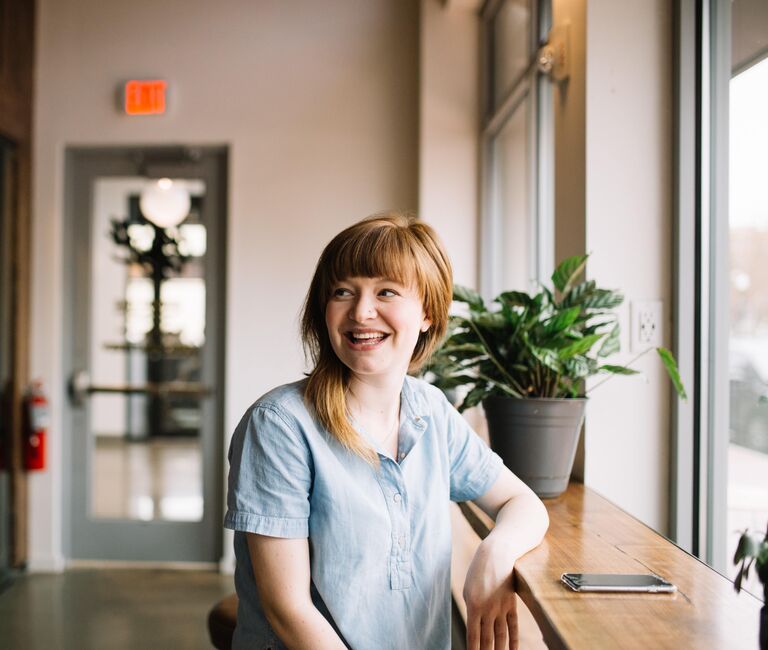 Smiling lady by a window