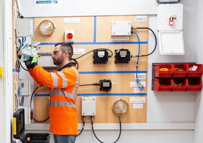 a man in high vis working in a construction workshop