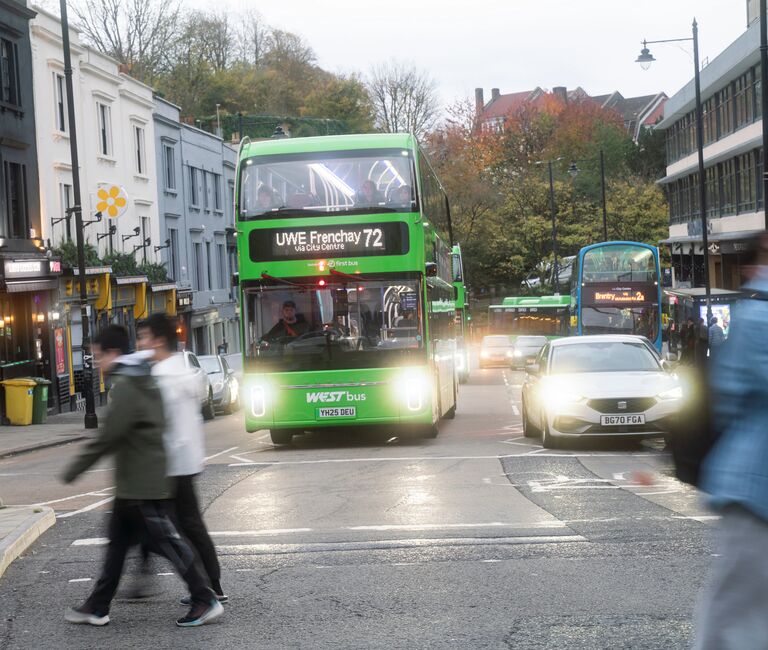 Bus, car and walking people
