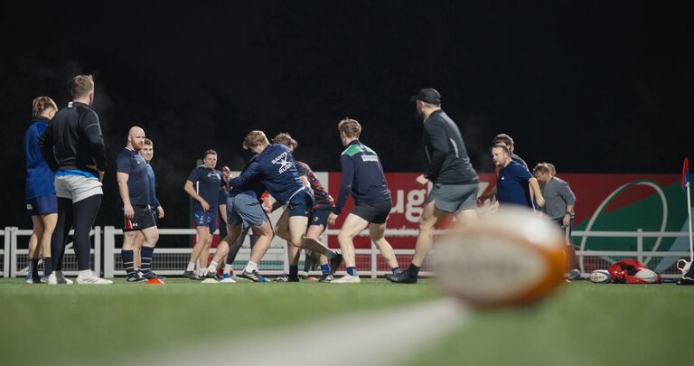 rugby players in blue shirts on the pitch