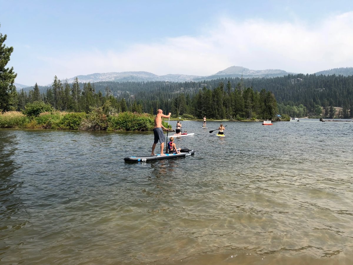 family paddle boarding in meanders
