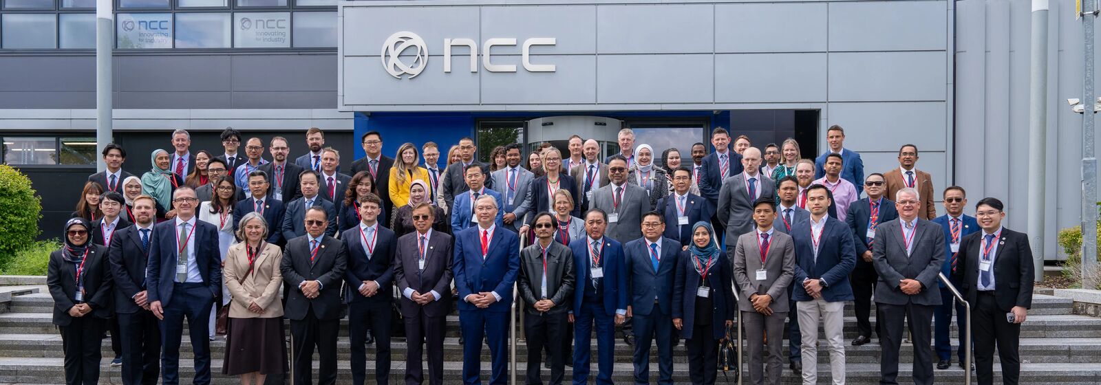 a large group of people wearing suits standing in front of NCC in Bristol & Bath Science Park
