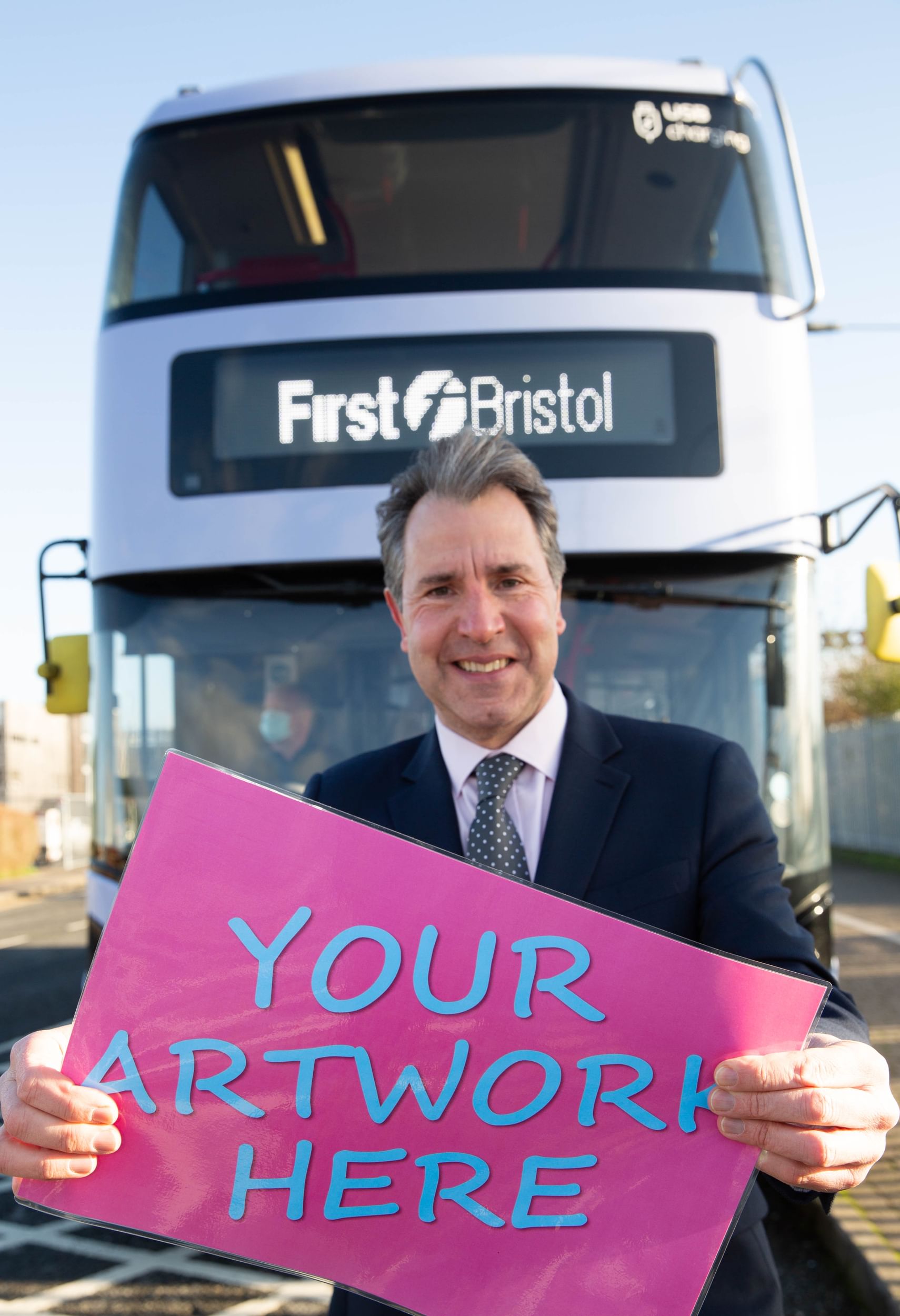 West of England Metro Mayor Dan Norris in front of bus with sign reading: 