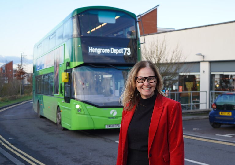 Helen Godwin in front of a bus