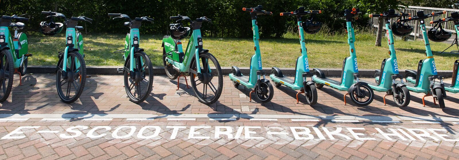 E-bikes and e-scooters are pictured, in a marked parking bay at Lyde Green Park & Ride travel hub.