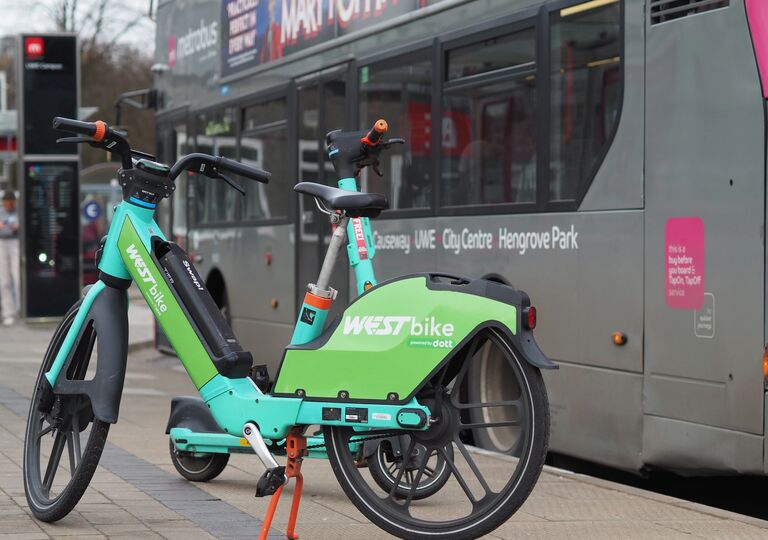e-scooter in front of a bus