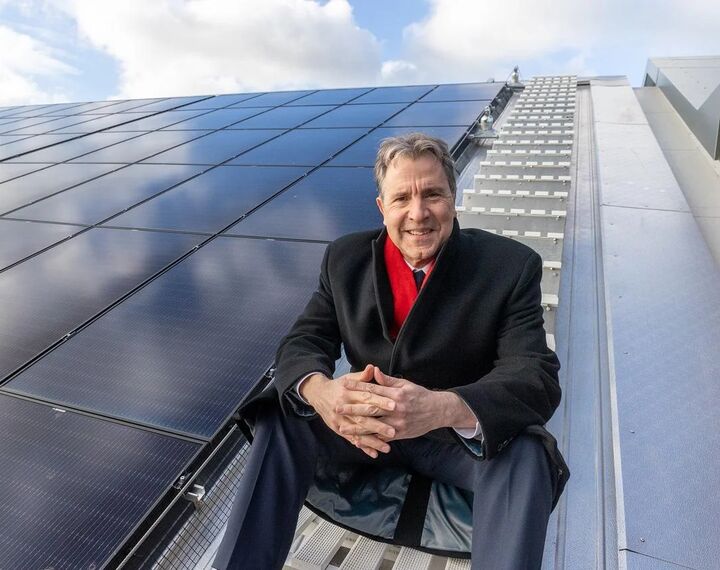 Mayor Dan Norris is pictured, alongside solar panels.