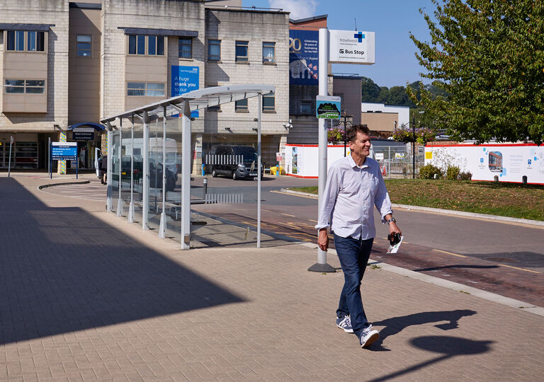 Man walking from bus stop